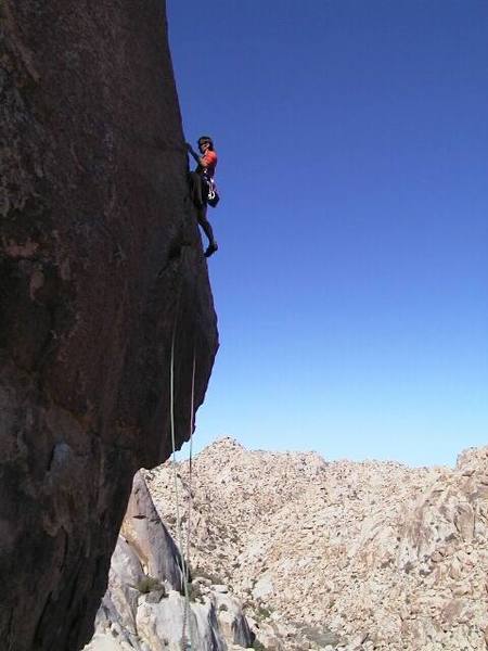 Placing a solid BD stopper in a fissure at the base of the arete. Photo by H. Harris.