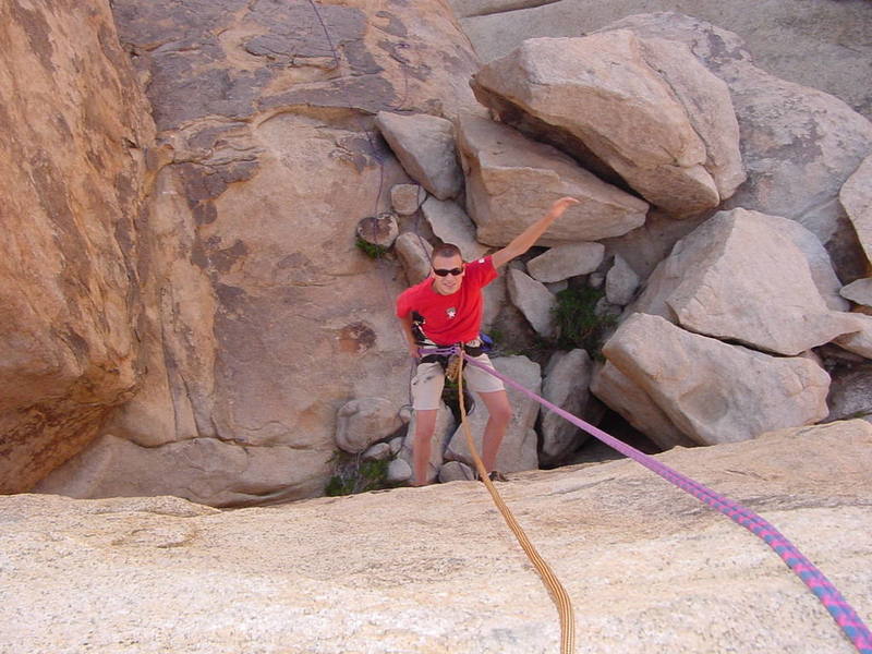 Rapping off the main block (to the right of the upper notch) on a rappel chain. When you reach the notch, make sure to climb this last block for the INCREDIBLE view!