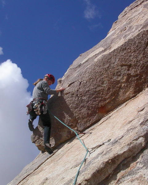 Christa Cline making the step onto the arete.