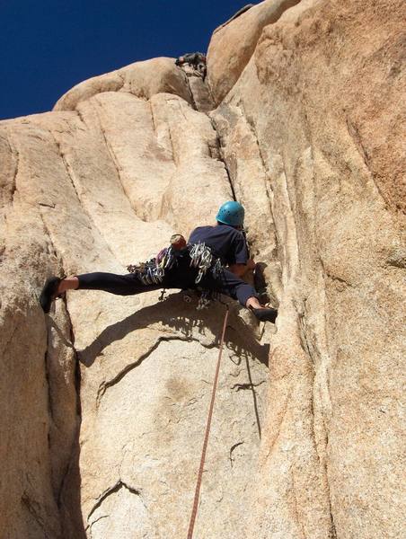 Chris in the lower stemming section of the route. Another climber is topping out in the chimney section.