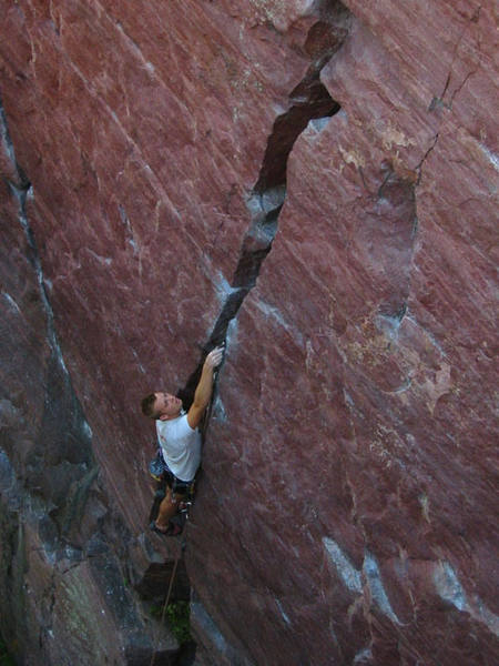 Travis Melin placing pro on the crux of Birch Tree crack 5.8. Photo Mike Lopera.
