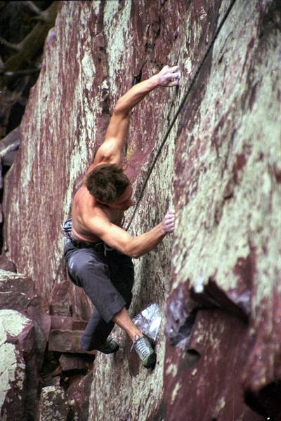 Beginning the mantle sequence. The move is not especially powerful, but very subtle. Once your right foot is on the good hold, standing up on the foot is the crux of the route.