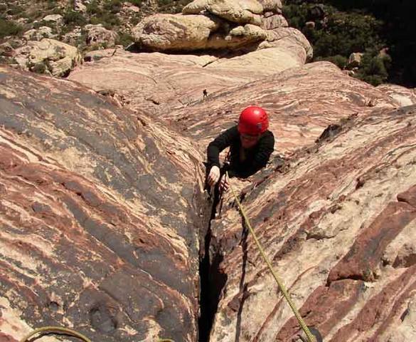 The moves over the bulge on pitch 6 of MysterZ. A second climber can be seen far below crossing the third class slabs on pitch 4.