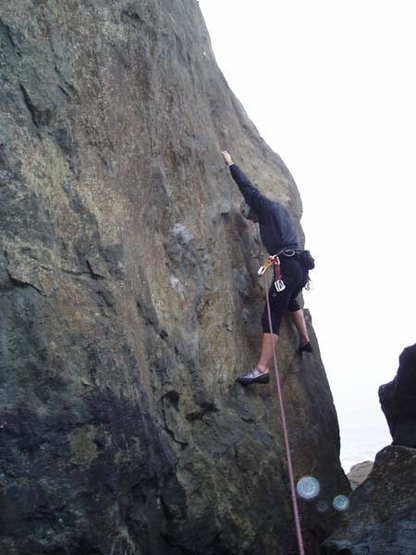 Traversing right from the first bolt on a foggy day.