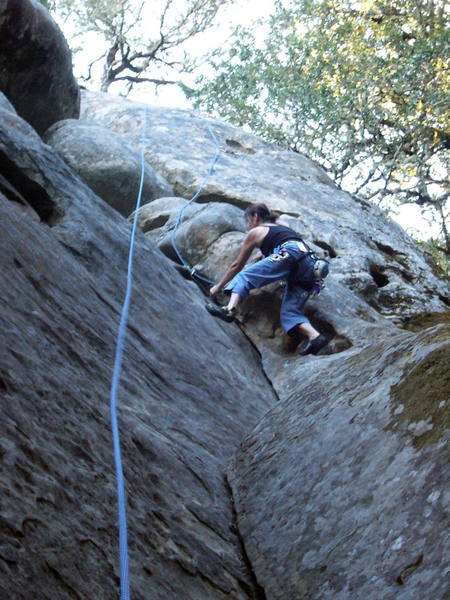 Sallie at the top of the 5.6 dihedral. Moving left here is the crux of the corner.