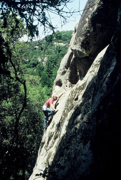 Climber completing the 5.10c slab crux before confronting the final 5.11a roof of "Putrefaction" (5.11a), Castle Rock Falls, CRSP, California