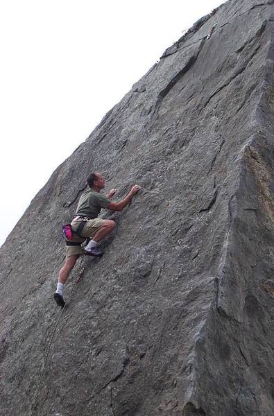 Paul reaching easier ground past second bolt. Easy climbing for 12' to final anchor.
