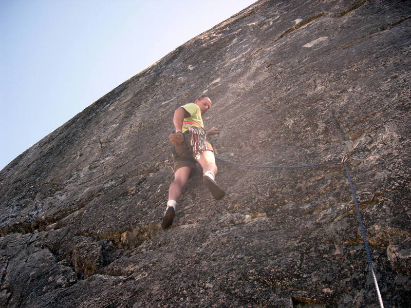 Paul at second bolt. Climb continues up through the slightly whitish rock above. That's where the fun starts!