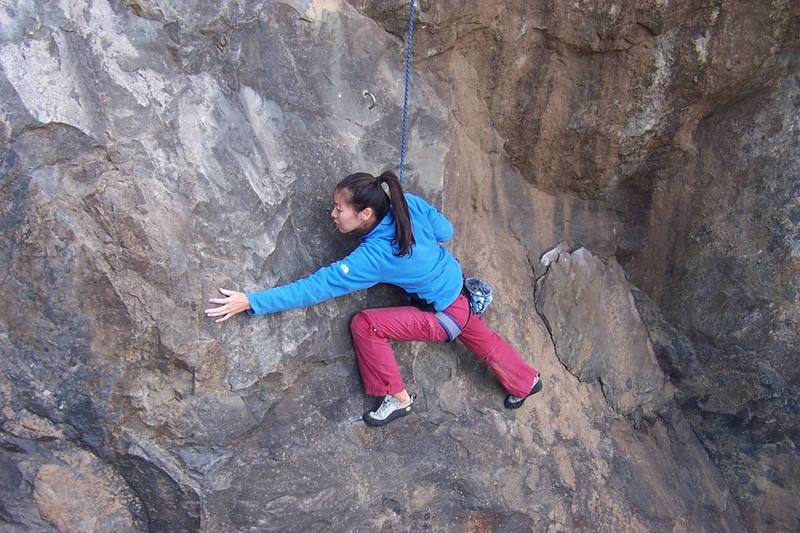 Naoko staying low on the bottom of the climb. She needs to get to the handhold down and to her left about 8 inches.