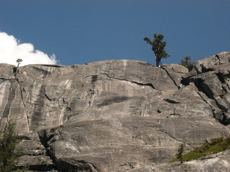 Photo shows the right side of the Upper Tier. Black streak on left side is Old Sea Hag (5.10). Towards the right side Country Bumpkin (5.10c) goes up the face to large overhanging flake and up face to top. The bottom third of photo is Middle Tier.