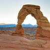 Delicate Arch at sunrise with La Sal Mountains
