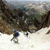 Hikers descending the gully, not far from the summit. The 13,500 ft saddle can be seen in the distance.