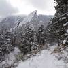A snowy start of the Mesa Trail looking at the first Flatiron.