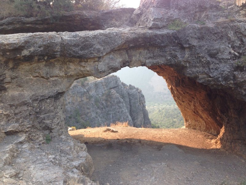A view into the wind caves from the entrance, with Logan Canyon showing down below