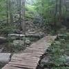 The old embankment for the 175 foot trestle that use to cross Fagan Creek. The old stone footings are not used to support a trail bridge.