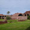 Standing in the inner grounds, looking toward the powder magazine with the arched roof.