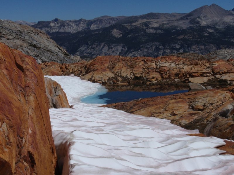 Red rocks and snow mingle on Red Peak Pass.