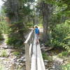 Crossing a stream on the Aster Park / Cobalt Lake Trail.