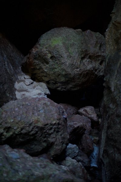 Rocks that have to be climbed over in the cave.  You can notice the creek running through the cave.