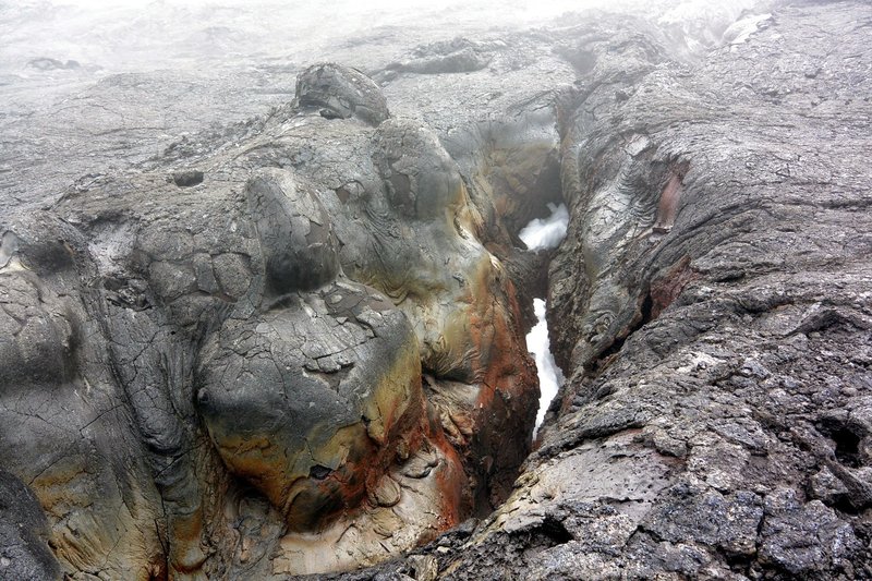 Snow, lava and rain - volcanic crack above Lua Poholo crater - part of Mauna Loa Caldera system. with permission from Andrew Stehlik