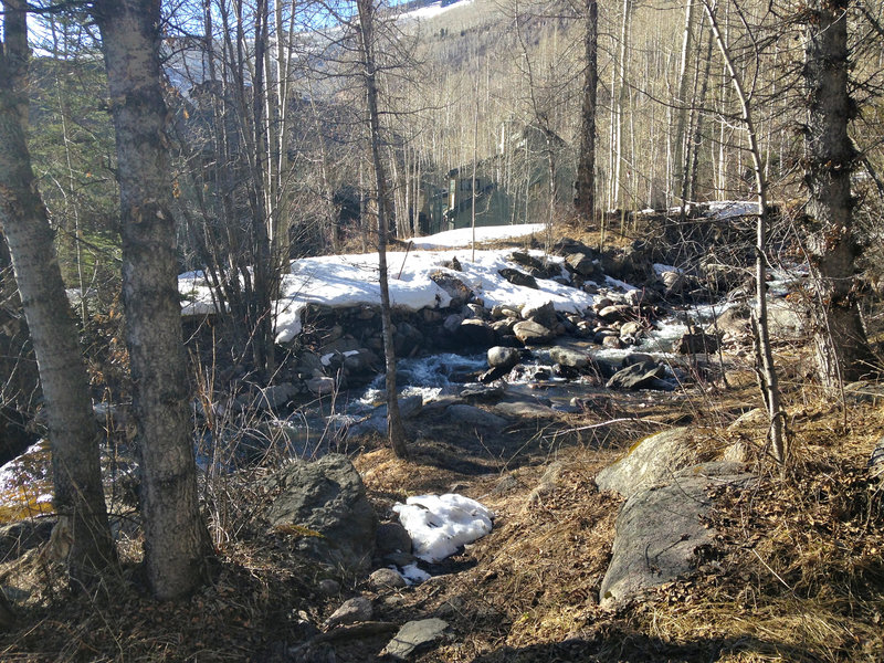 View from near the trailhead in early spring (late March), with patches of snow still covering portions of the lower trail.