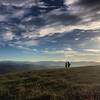 The Peoples Trail - A photo shot of a couple along the Appalachian Trail from atop Max Patch Mountain in Pisgah National Forest. There are many stunning views along the 2,200-mile east coast trail, but nothing quite like the panoramic scene of the Blue Ridge Mountains.