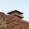 The fire lookout sits at the summit atop lava splatters.