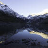 The sun rising over Gunsight Lake on a chilly morning.