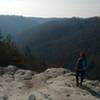 A hiker gazes out onto the gorge from the overlook along the Grand Gap Loop Trail.