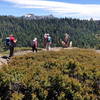 Hikers stop at an overlook along the Sterling Canyon Trail to take in the view of the Sierra Crest at Donner Summit.