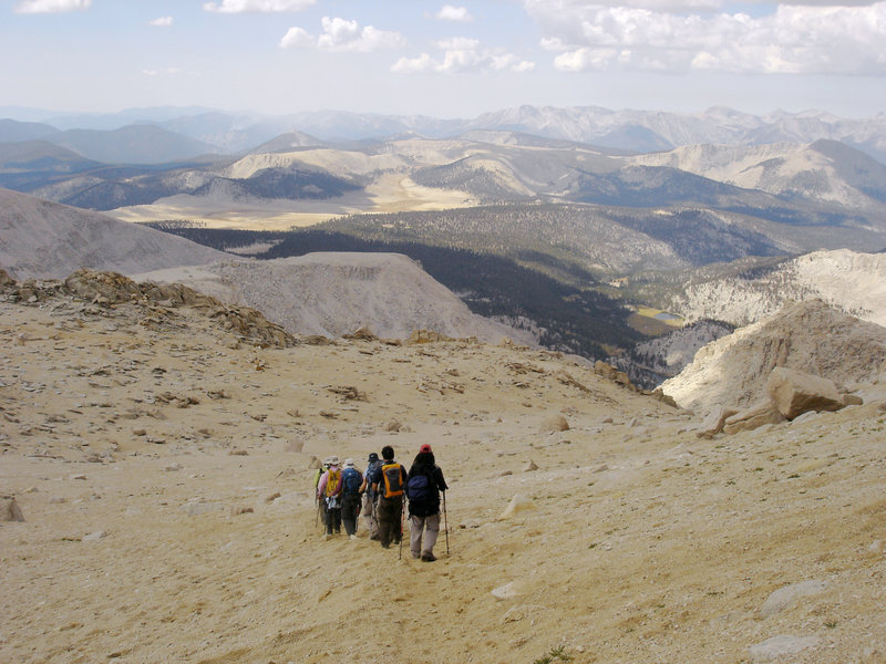 A group of hikers looks out over Sequoia National Park on the way down from Mount Langley.