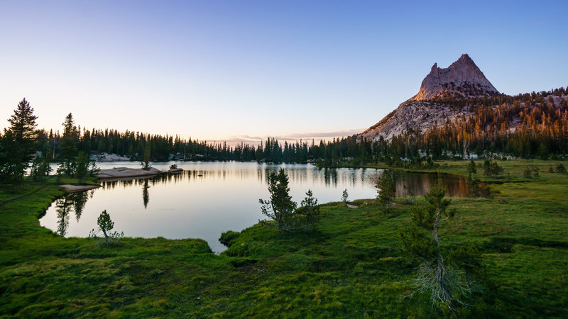 Evening brings a sublime sunset at Upper Cathedral Lake on the John Muir Trail in Yosemite National Park.