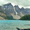 Moraine Lake is nestled within the Valley of Ten Peaks. Left-to-right is the base of the Tower of Babel, Mt. Babel, Mt. Fay, Tonsa Peak, and Mt. Allen (in a cloud).