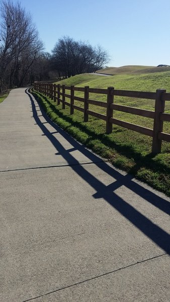 The trail is beautifully paved as it heads toward the golf course.