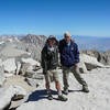Tired and happy to be on the summit of Mt. Whitney, a pair of hikers enjoys their accomplishment.