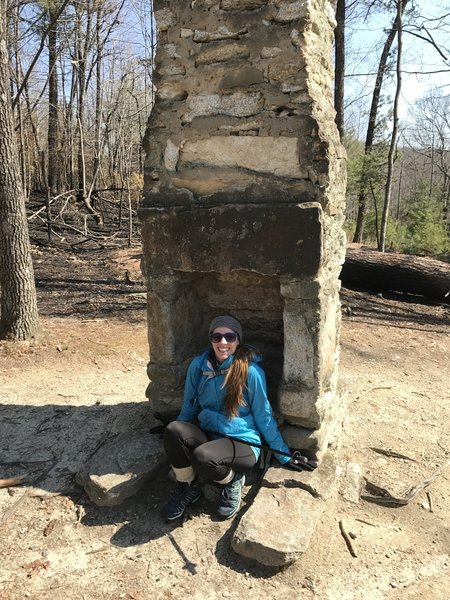 A human-sized chimney marks the intersection of the Stone Mountain Loop Trail and the spur to the upper parking area.