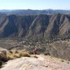 A hiker ascends the steep prow of El Cajon Mountain.