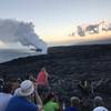 A mass of people watch the sunset at the Kamokuna ocean lava viewing area.