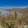View of Storm King Mountain on left, Breakneck Ridge center across river, and Mt. Taurus on right across river.