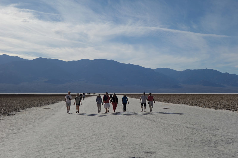 Hikers return from Badwater Basin along this hard baked alkali plain.