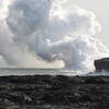Steam billows from active lava flows plunging into the sea.
