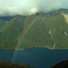 A rainbow forms over Lake Rotoiti on a snow-showery day high on Paddy's Track.