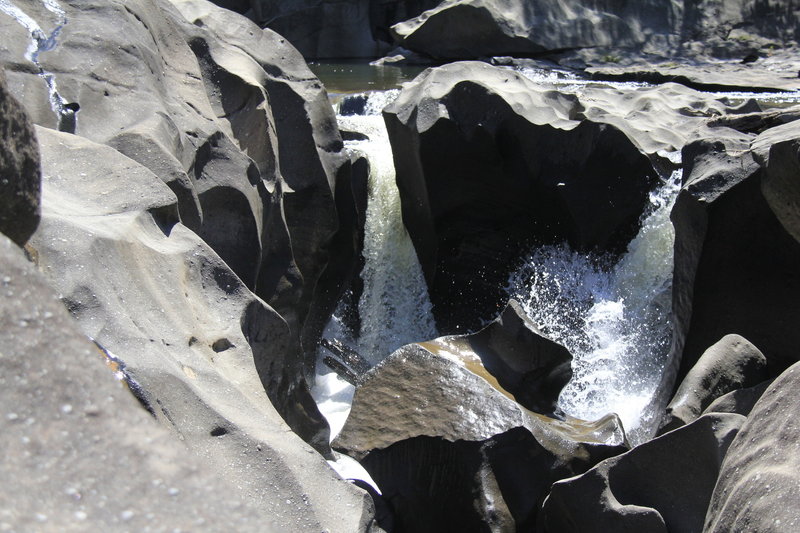 Cool rock formations are carved by the water at Vale da Lua.