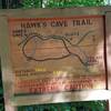 An informative sign marks the entrance to the Hawk's Cave Trail.
