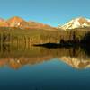 Manzanita Lake mirrors Chaos Crags on the left, and Mt. Lassen on the right, on a warm summer evening.