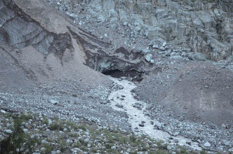 Carbon Glacier melt flows down the nearby rocky slopes.