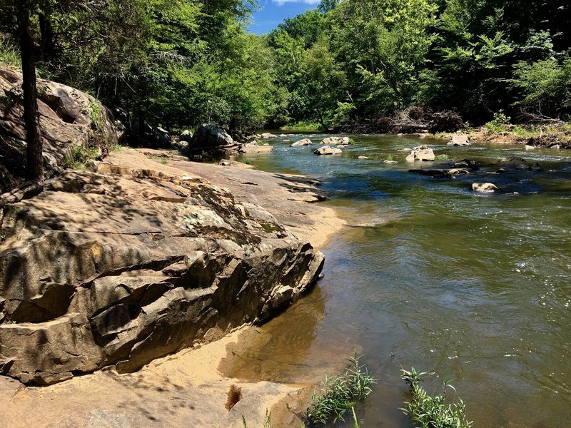 A rocky slab juts out from under the Eno.