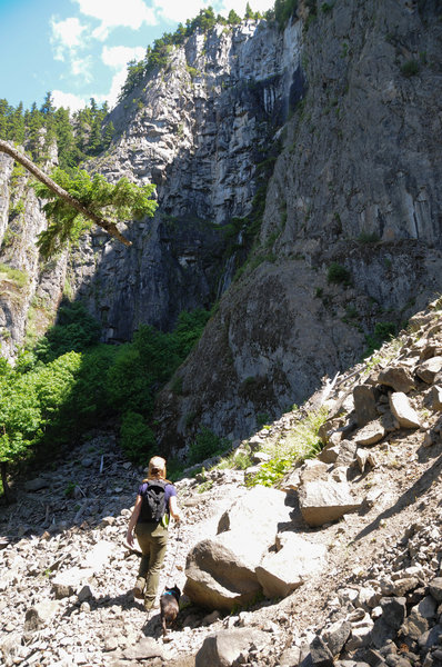 The trail opens to views of cliffs and Snoquera Falls.