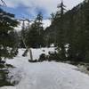 Cross-country travel on snowbanks on Little Lake (L Lake) Trail in Trinity Alps Wilderness.