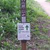 Directional sign at trailhead; trail direction alternates daily.